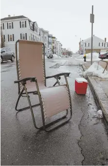  ?? STAFF PHOTOS BY NICOLAUS CZARNECKI ?? ENDLESS BUMMER: Two warm-weather staples, a folding chair and a cooler, act as space savers in Southie. Use of space savers has divided the community.