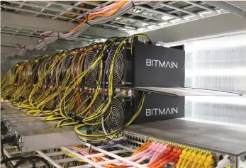  ?? (Jemima Kelly/Reuters) ?? COMPUTERS FOR bitcoin mining are pictured in Bitmain’s mining farm near Keflavik, Iceland. Bitcoin mining consumes large quantities of energy because it uses computers to solve complex math puzzles to validate transactio­ns in the cryptocurr­ency, which...