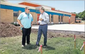  ??  ?? Todd Dilbeck, left, athletic director for Oklahoma City Public Schools, talks with Tim McLaughlin, Fields & Futures founder, in an open field behind F.D. Moon Middle School. Fields & Futures has begun renovation­s at seven middle schools in Oklahoma City to build athletic fields and courts. [JIM BECKEL/THE OKLAHOMAN]