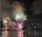  ?? KATHY WILLENS ASSOCIATED PRESS ?? A surprise display of fireworks sponsored by Macy’s explode over the Hudson Yards area of Manhattan as seen from a pier in Hoboken, N.J., late Tuesday. The fireworks were not announced until an hour or so before to avoid attracting large crowds during the coronaviru­s pandemic.