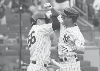  ?? ALTAFFER/AP
MARY ?? The Yankees’ Andrew Velazquez, right, celebrates with Kyle Higashioka after hitting his first career homer in the eighth inning Saturday against the Twins in New York. Velazquez, who grew up in the Bronx, had his family in the stands.