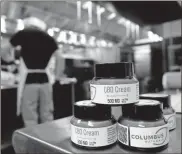  ?? Fred Squillante/columbus Dispatch/the Columbus Dispatch/tns ?? Columbus Naturals processes hemp to make CBD cream. As a result, owners Erik Bogard and Olivia Rojas had to call 20 banks to get an account.