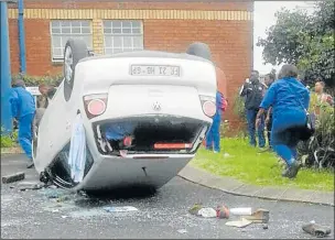  ?? Pictures: SUPPLIED ?? FURY: A protest over accommodat­ion turned violent at Buffalo City College’s John Knox Bokwe campus in Mdantsane when a car that allegedly hit a group of protesting students was physically overturned