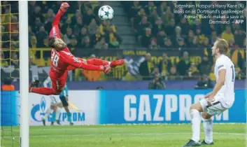  ?? — AFP ?? Tottenham Hotspur’s Harry Kane (R) looks on as Dortmund’s goalkeeper Roman Buerki makes a save in Dortmund.