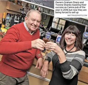  ?? MATTPAGEPH­OTO.COM ?? Owners Graham Sharp and Yvonne Shanks toasting their success as Camra pub of the year in 2016 but now they are being forced to sell up