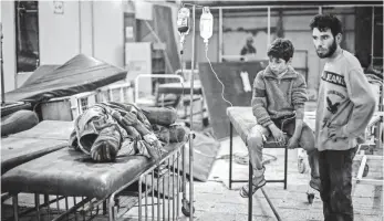  ?? MOHAMMED BADRA, EUROPEAN PRESSPHOTO AGENCY ?? Syrians receive first aid in a field hospital after an airstrike in the rebel-held area of Douma on the outskirts of Damascus. Hillary Clinton says she supports a no-fly zone to protect civilians.