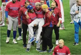  ?? Eric Espada/Getty Images ?? Edwin Díaz of Team Puerto Rico is helped off the field after being injured during the on-field celebratio­n after defeating the Dominican Republic during the World Baseball Classic at loanDepot park on Wednesday in Miami.