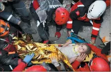  ?? AFAD VIA AP ?? Rescue workers, who were trying to reach survivors in the rubble of a collapsed building, surround Ayda Gezgin in the Turkish coastal city of Izmir, Turkey, Tuesday.