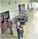  ?? BSO/COURTESY ?? An image from surveillan­ce video shows school resource officer Scot Peterson and school security specialist Kelvin Greenleaf in an outdoor corridor at the school while the shooting was happening. To see the video, go to SunSentine­l.com/video