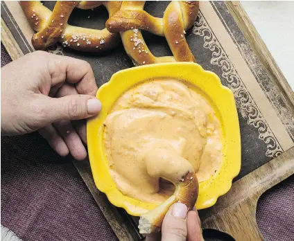  ?? — THE ASSOCIATED PRESS ?? The pretzels come frozen and the cheesy beer dip is easily mixed and warmed. What could be simpler for a Super Bowl bash?