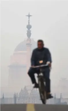  ??  ?? A man cycles near the Indian President’s house amid heavy smog in New Delhi.