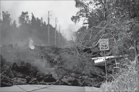  ?? MARCO GARCIA/AP PHOTO ?? Power lines are pulled down by lava in the Leilani Estates on Saturday in Pahoa, Hawaii. The Hawaiian Volcanoes Observator­y said eight volcanic vents have opened in the Big Island residentia­l neighborho­od of Leilani Estates since Thursday.