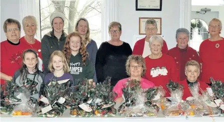  ?? SPECIAL TO THE EXAMINER ?? Members of the Norwood Lioness and their helpers get ready to deliver a little festive good cheer in the form of a specially prepared lunch of homemade sandwiches and goodies to seniors in the village who find themselves alone this Christmas.