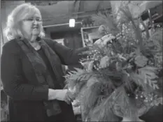  ??  ?? Right: The Garden Club of Hamilton is decorating Dundurn Castle for Christmas. Wendy Downing creates an arrangemen­t.