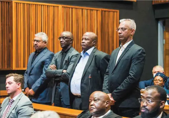  ?? Photo: Delwyn Verasamy ?? Off the rails: Brian Molefe (third from left) and Anoj Singh (right) appear in court. The two, along with Siyabonga Gama, were arrested over their alleged role in state capture, regarding Transnet.