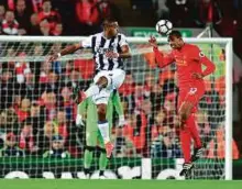  ?? AP ?? Liverpool’s defenderJo­el Matip (right) nods clear from West Bromwich Albion’s striker Salomon Rondon at Anfield on Saturday.