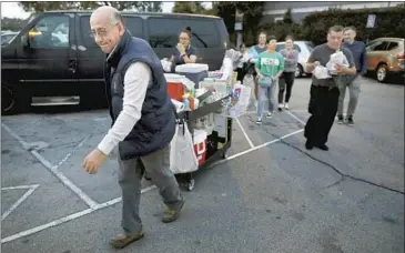  ?? Gary Coronado Los Angeles Times ?? CUSTOMERS could barely wait for Andres Santos to set up at his Highland Park spot so they could buy his corn. Now they’re having to say goodbye: After more than 20 years, he’s returning to Mexico to start over.