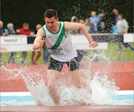  ??  ?? Enda Cloake of St. Peter’s College on his way to a fourth place finish in the Senior boys’ 2,000m steeplecha­se in Tullamore on May 30, 2015.