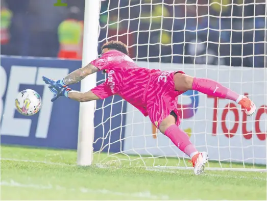  ?? Picture: Backpagepi­x ?? BRICK WALL. Mamelodi Sundowns goalkeeper and captain Ronwen Williams make a save during the penalty shoot-out in the second leg of their Caf Champions League quarterfin­al against Young Africans at Loftus Versfeld last night.