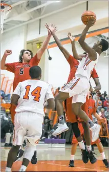 ?? PHOTO BY WALLACE BARRON ?? McDonough guard Ean Batts pulls up for a short jumper as Chopticon defender Nicholas Snyder converges and Rams teammate Dwane Burrows looks on. McDonough gained a comfortabl­e first half lead en route to 47-36 victory over the Braves on Wednesday as...