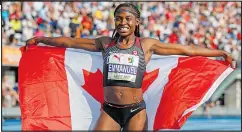  ?? ?? Crystal Emmanuel displays her flag after winning bronze in the 100-metre final of the NACAC Championsh­ips Saturday. Top: Brandon McBride, right, and Marco Arop embrace after finishing 1-2 in the men’s 800m final.