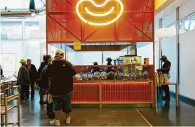  ?? Michaela Vatcheva/Special to the Chronicle ?? Customers wait at Snöberg at Saluhall in S.F. The Scandinavi­an-style food hall opened last week in the retail center owned by IKEA sister company Ingka Centre.