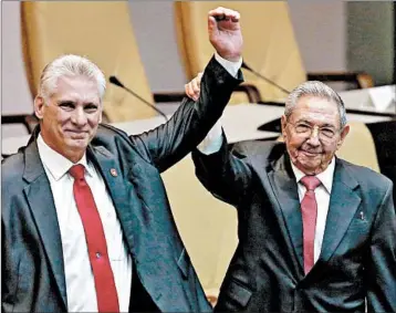  ?? ALEXANDRE MENEGHINI/REUTERS ?? New President Miguel Diaz-Canel, left, and Raul Castro present a gesture of unity Thursday to Cuba’s National Assembly.