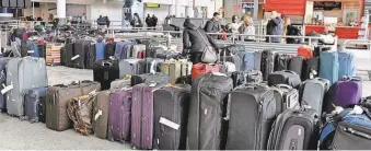  ?? RICHARD DREW/ AP ?? Unclaimed baggage sits at New York’s John F. Kennedy Airport on Jan. 8, after a water pipe burst. A rule that requires airlines to refund bag fees if your luggage arrives late has languished.