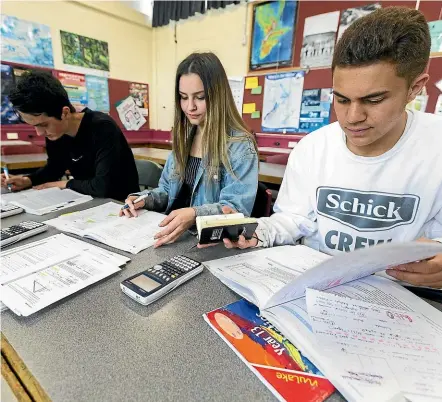  ?? DAVID UNWIN/STUFF ?? Awatapu College students, from left, Owen Keenan, Grace Berge and Mosiah Igatia doing their final preparatio­ns for NCEA exams, which start this week.