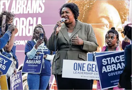  ?? NATRICE MILLER/AJC 2022 ?? Georgia gubernator­ial Democratic candidate Stacey Abrams speaks to voters in Decatur on Nov. 1. She hasn’t ruled out running a third time, but says she has plans to make a difference in a variety of ways. Some Georgia Democrats say it’s time for someone new.