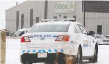  ?? DAVID BLOOM ?? RCMP officers watch as Gracelife Church parishione­rs arrive for an in-person Sunday service. The church held the service despite a public health closure order and its pastor in custody.