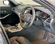  ?? PHOTOS: DAMIEN O’CARROLL/STUFF ?? The 330e’s interior is of a high quality, but is a bit boringly conservati­ve.