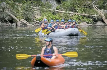  ?? Lake Fong/Post-Gazette ?? Whitewater adventurer­s raft and kayak Wednesday on the Youghioghe­ny River at Ohiopyle State Park, one of many regional destinatio­ns for travelers over Labor Day weekend.
