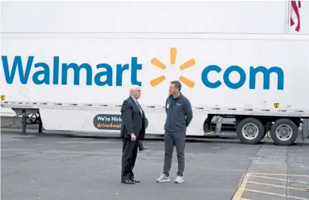  ?? Anna Moneymaker, © The New York Times Co. file ?? Vice President Mike Pence and Walmart CEO Doug McMillon take a tour of a Walmart distributi­on center in Gordonsvil­le, Va., on April 27.