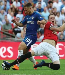  ?? PICTURES: ANDY HOOPER ?? Fast track: Eden Hazard hits top gear to speed clear of Phil Jones before drawing the foul for the penalty, which he converted to win it the Cup for Chelsea