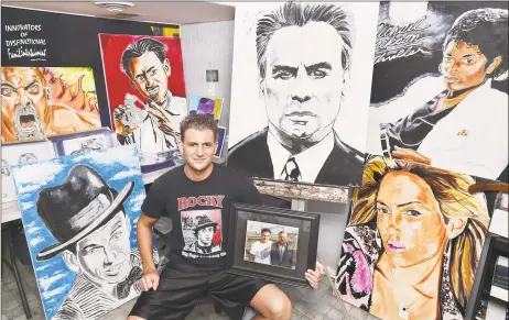  ?? Catherine Avalone / Hearst Connecticu­t Media ?? Artist Pauly Popolizio at his home studio in Hamden with a few of his celebrity portraits.