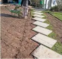  ?? GETTY IMAGES ?? Removal of old turf around a new stepping stone walkway in preparatio­n for the installati­on of a new turf lawn.