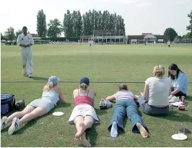  ??  ?? Relaxing: Fans stretch out at Mote Park, Maidstone