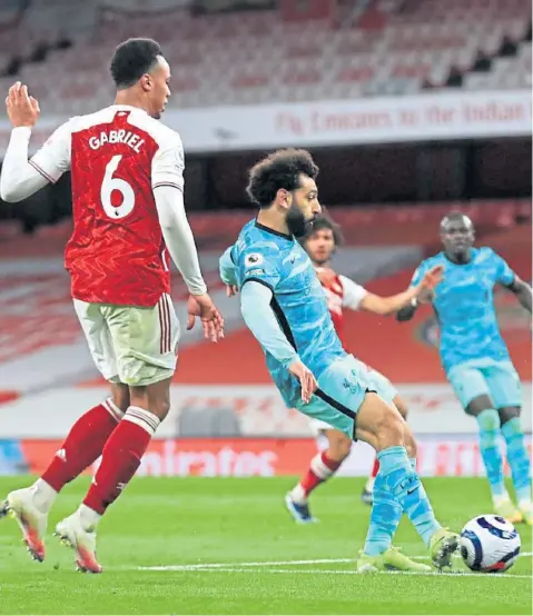  ??  ?? Liverpool’s Mohamed Salah scores their second goal against Arsenal
