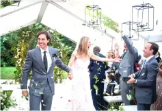  ??  ?? (Above) Gwyneth Paltrow and her producer husband Brad Falchuk are seen walking handin-hand down the aisle at the ceremony held in the backyard of Paltrow's home in East Hampton, New York.