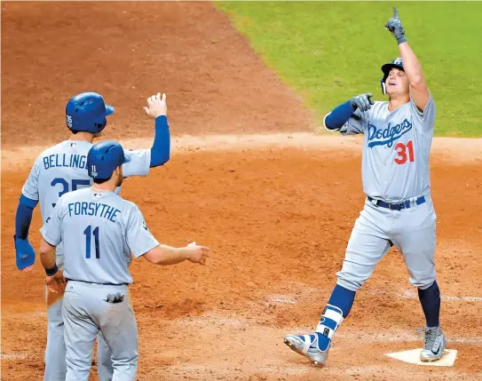  ?? UPI-Yonhap ?? Los Angeles Dodgers Joc Pederson, right, celebrates his three-run home run against the Houston Astros with Cody Bellinger and Logan Forsythe in the ninth inning of the 2017 MLB World Series Game 4 at Minute Maid Park in Houston, Texas, on Saturday. The...