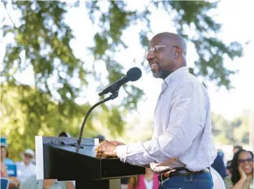  ?? JASON GETZ/THE ATLANTA JOURNAL-CONSTITUTI­ON ?? Sen. Raphael Warnock, D-Ga., who is locked in a tight reelection campaign, now speaks little of the checks of up to $1,400 that Democrats had delivered for those digging out of the pandemic recession.