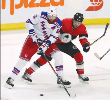  ?? The Canadian Press ?? New York Rangers forward Rick Nash, left, and Ottawa Senators defenceman Cody Ceci battle for the puck during NHL action in Ottawa last Saturday. Nash has been a healthy scratch this week in anticipati­on of being traded.