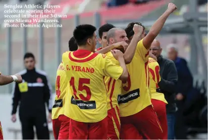  ??  ?? Senglea Athletic players celebrate scoring their second in their fine 3-0 win over Sliema Wanderers. Photo: Dominic Aquilina