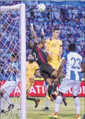  ??  ?? Honduras' goalkeeper Donis Escober (in black) jumps for the ball during the first leg football match of their 2018 World Cup qualifying play-off against Australia.