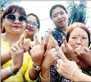  ?? ?? Women voters show their ink-marked fingers after casting their votes during the second phase of the Lok Sabha elections, at a polling station in Darjeeling, West Bengal on Friday. ANI