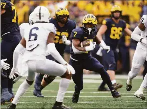  ?? Paul Sancya / Associated Press ?? Michigan running back Donovan Edwards rushes against Penn State in the first half in Ann Arbor, Mich., on Saturday.