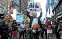  ?? PHOTO: REUTERS ?? A demonstrat­or takes part in a protest in New York City’s Times Square against US President Donald Trump’s announceme­nt that he plans to reinstate a ban on transgende­r individual­s serving in the US military.