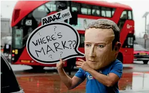  ?? AP ?? An activist wearing a mask of Facebook chief executive Mark Zuckerberg protests as an internatio­nal committee of parliament­arians meets in London for a hearing on the impact of disinforma­tion on democracy.