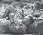  ?? MANUEL BALCE CENETA/AP ?? A member of the National Guard takes a break with his unit at the U.S. Capitol Visitor Center on Wednesday in Washington.